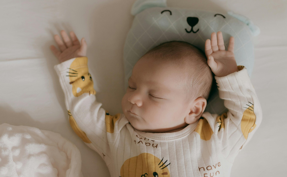 A sleeping newborn baby in a cozy nursery setting, surrounded by soft lighting and calm decor, a peaceful moment inspired by Fresh Hug comfort