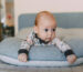 baby having tummy time on feeding pillow